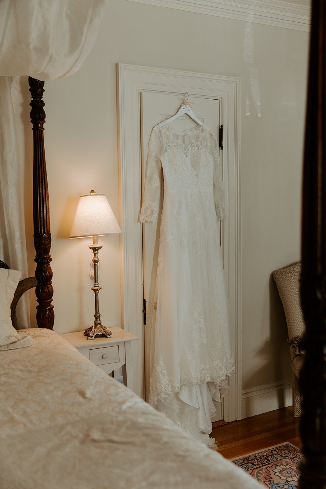 A wedding dress hanging up in the getting ready suite at Glen Magna Farms