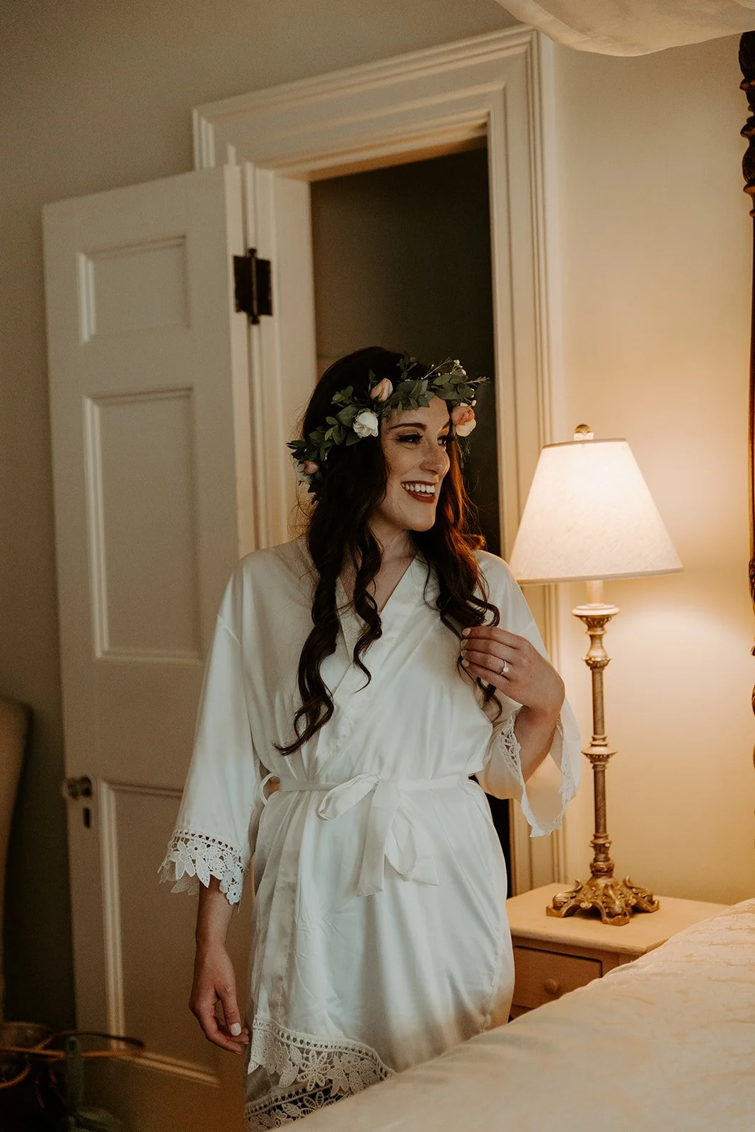 A bride in a flower crown getting ready for her wedding
