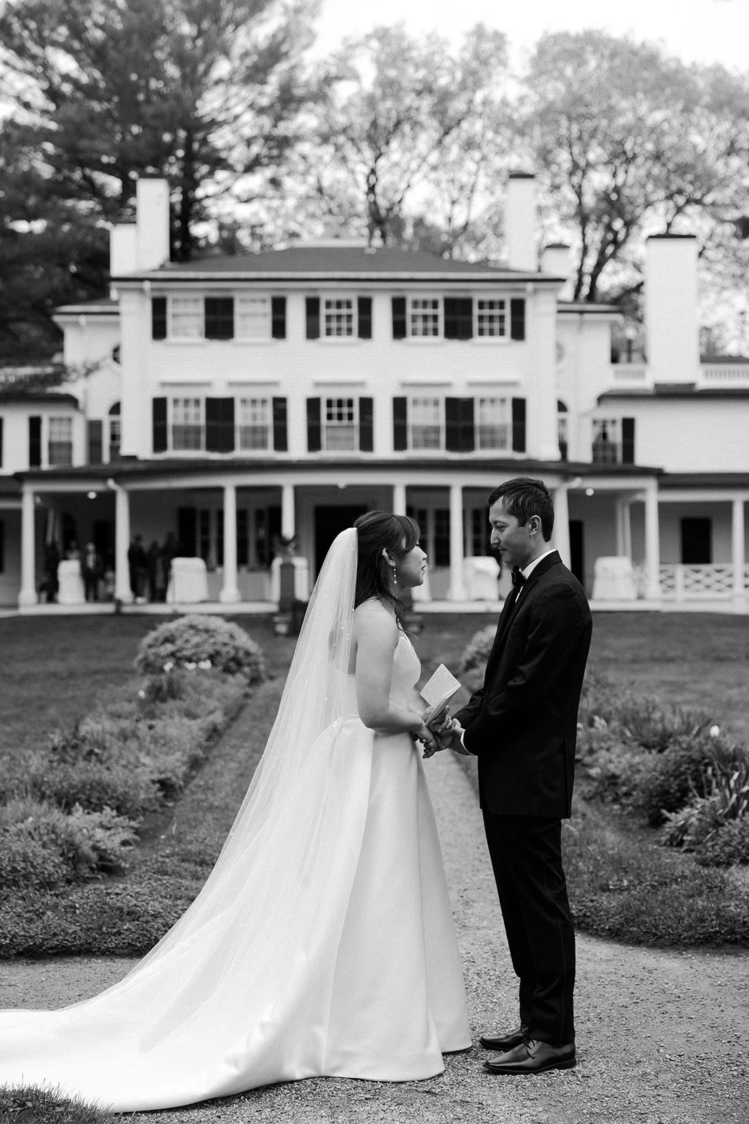 A couple reading their private vows in front of their estate wedding venue