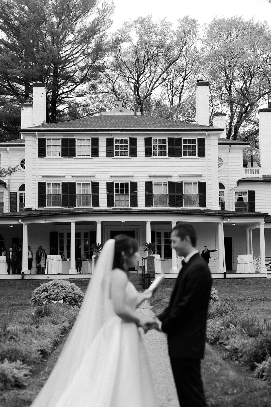 A couple reading their private vows in front of their estate wedding venue