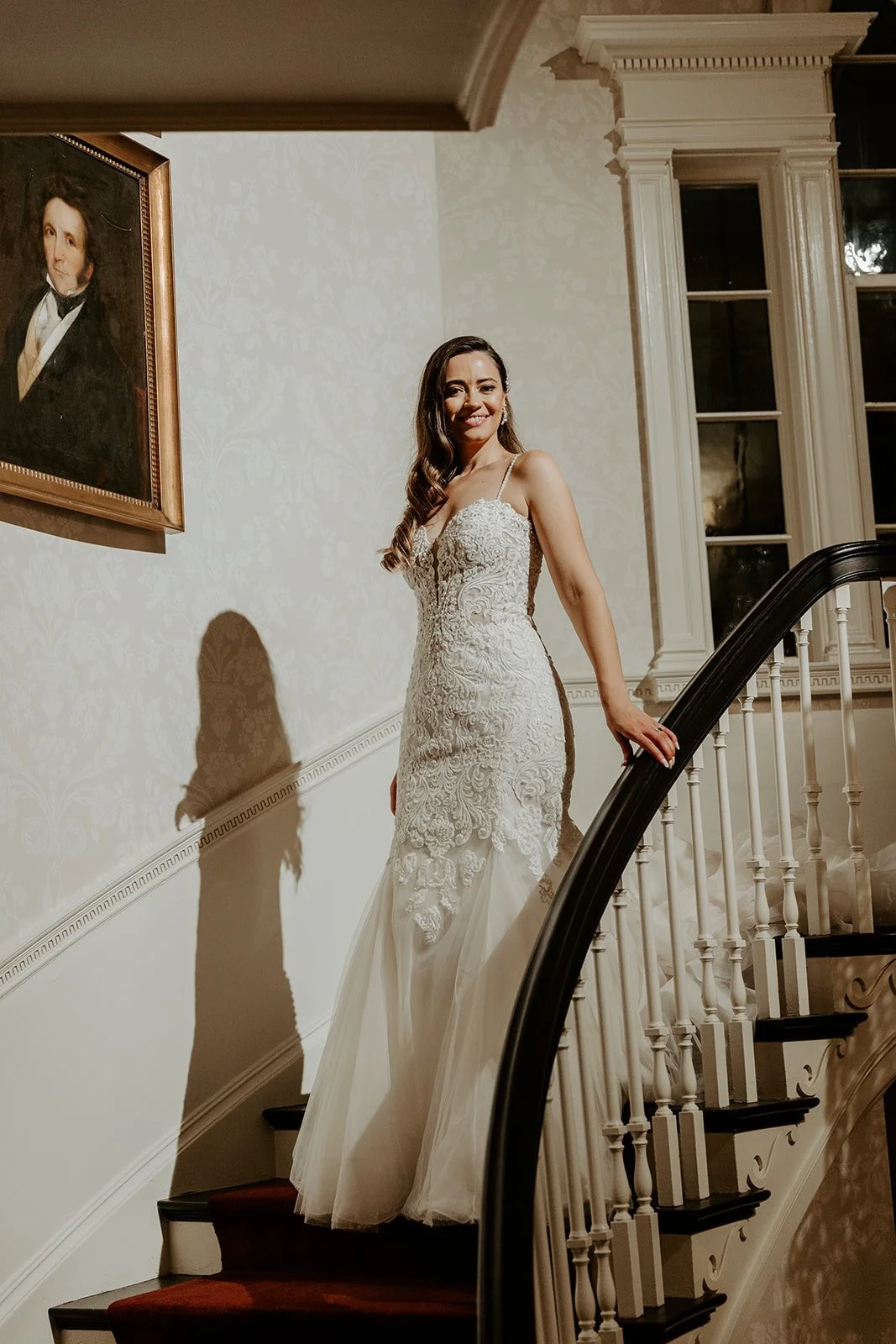 A bride walking down the staircase inside of Glen Magna