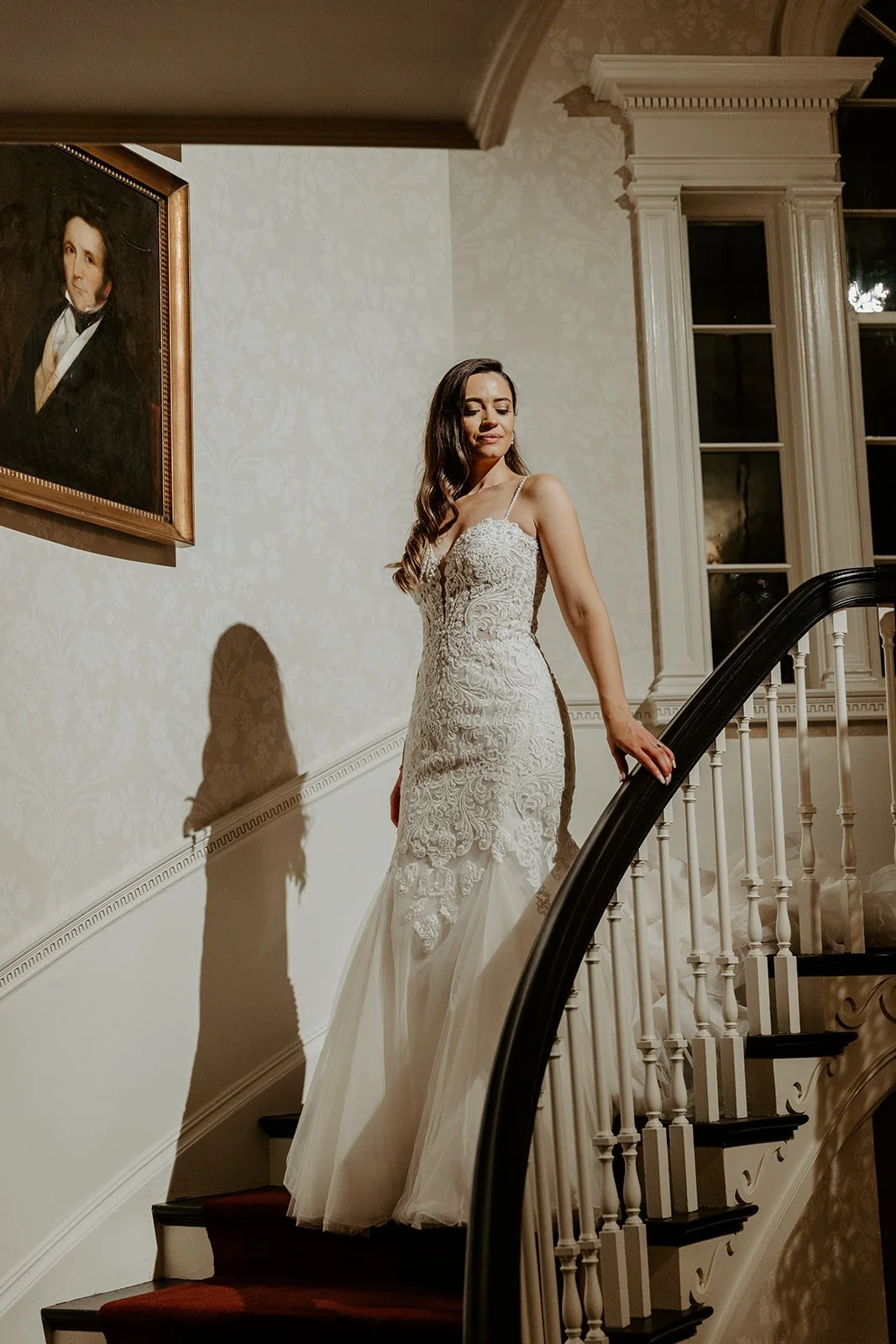 A bride walking down the staircase inside of Glen Magna