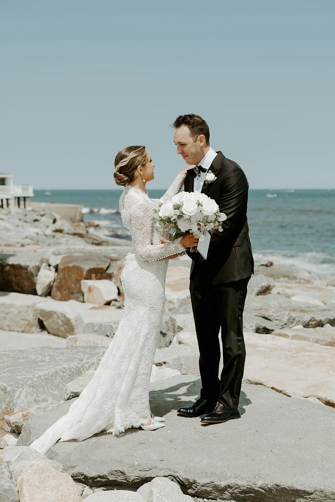 A bride and groom posing at a waterfront wedding venue in Boston showing how to plan a wedding