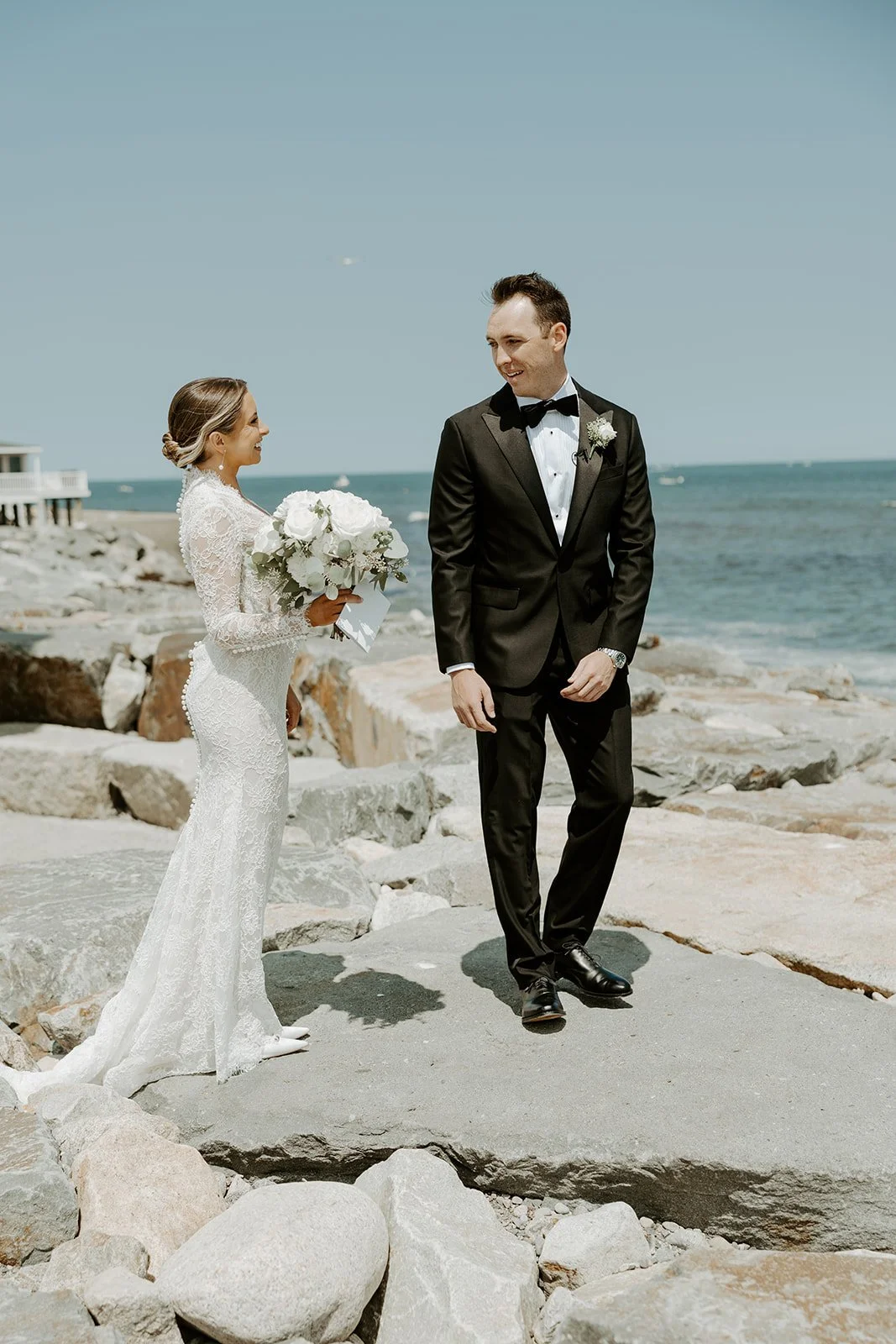 A bride and groom posing at a waterfront wedding venue in Boston showing how to plan a wedding