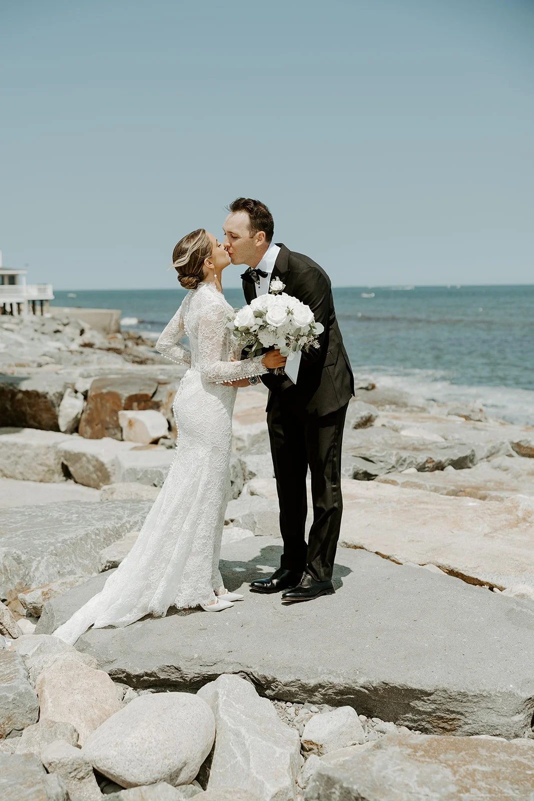 A bride and groom posing at a waterfront wedding venue in Boston showing how to plan a wedding