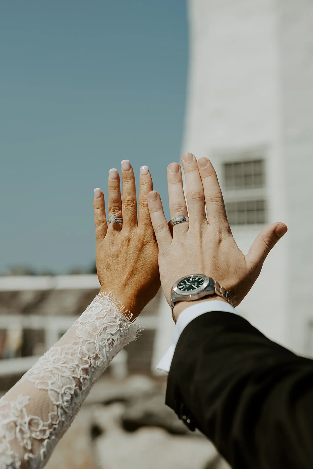 A bride and groom showing off their rings in a blog post about how to plan a wedding