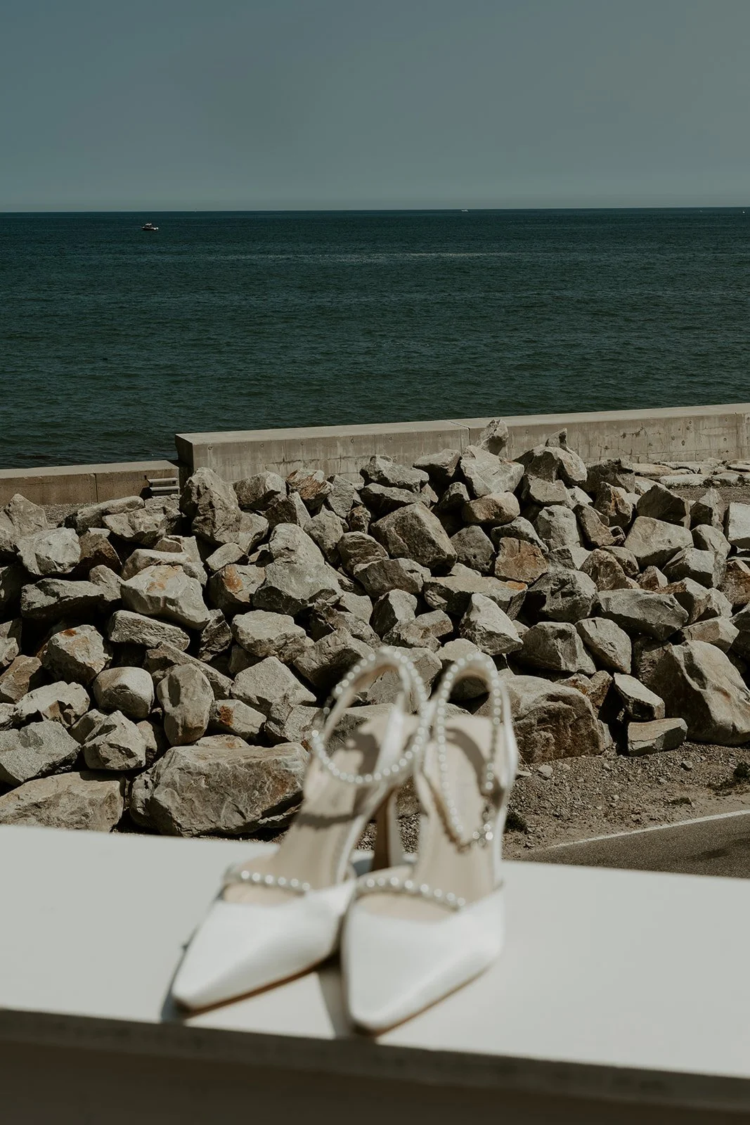 Wedding shoes in front of the ocean