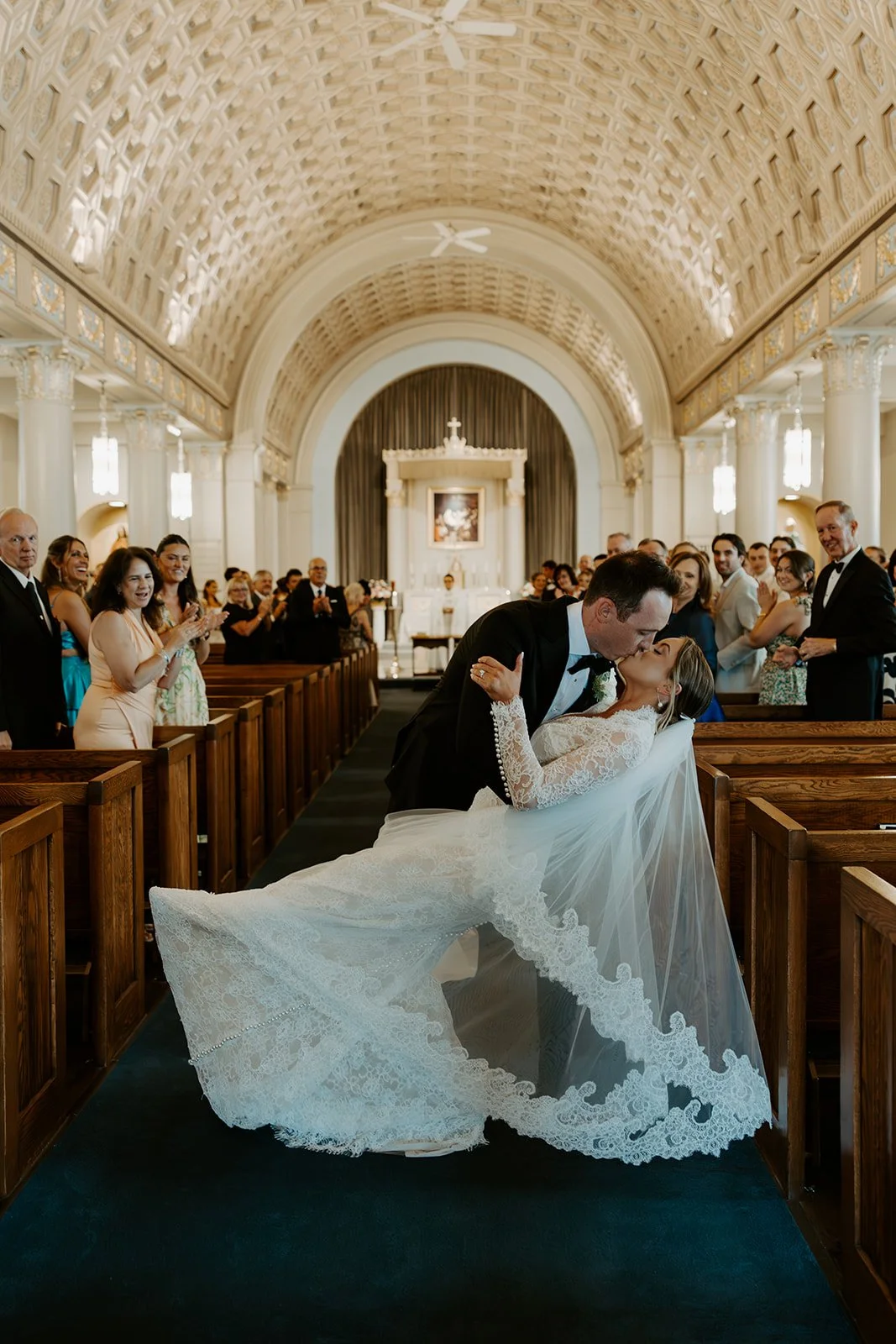 A bride and groom kissing after their wedding ceremony