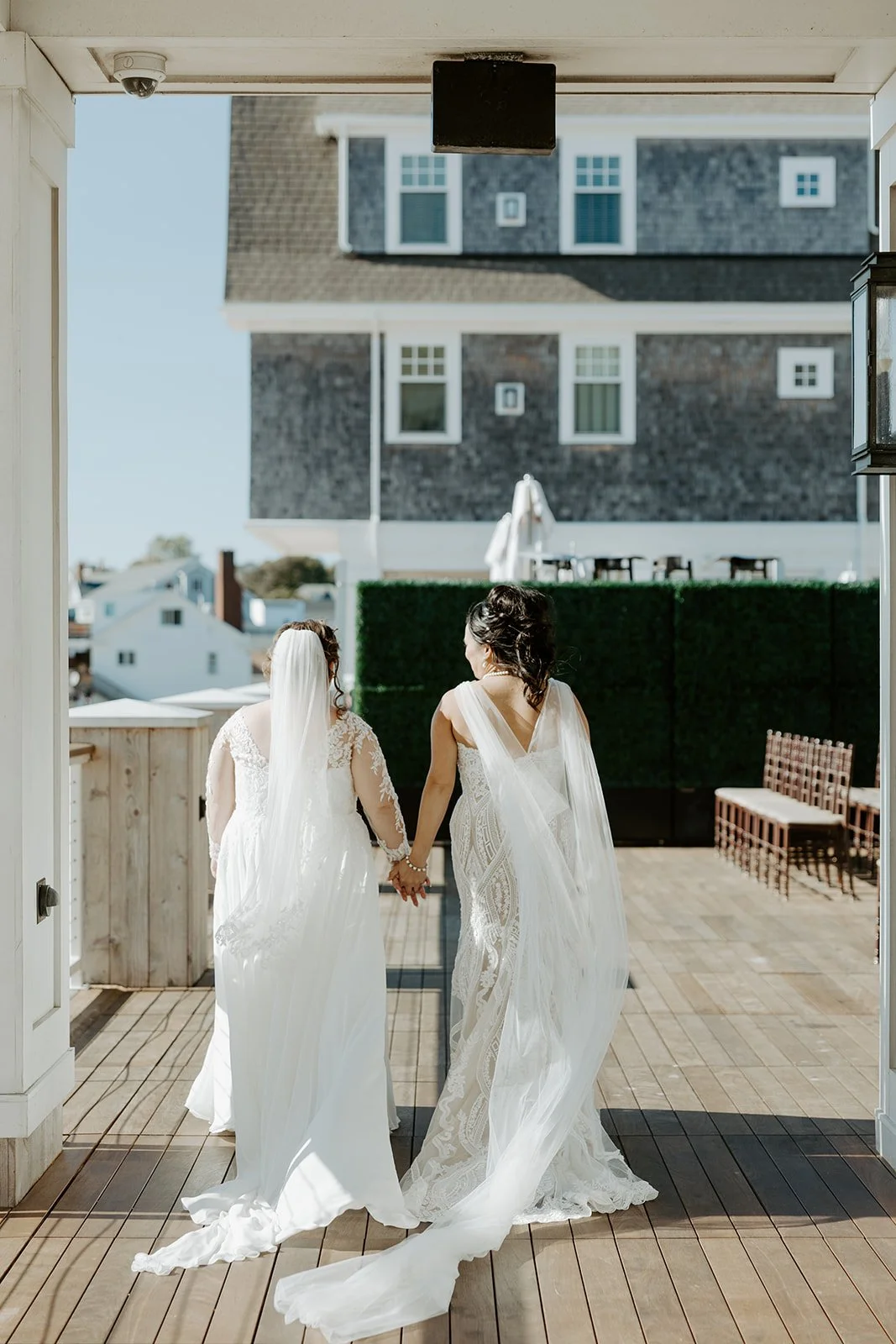 Two brides walking hand in hand at the beginning of a wedding planning checklist