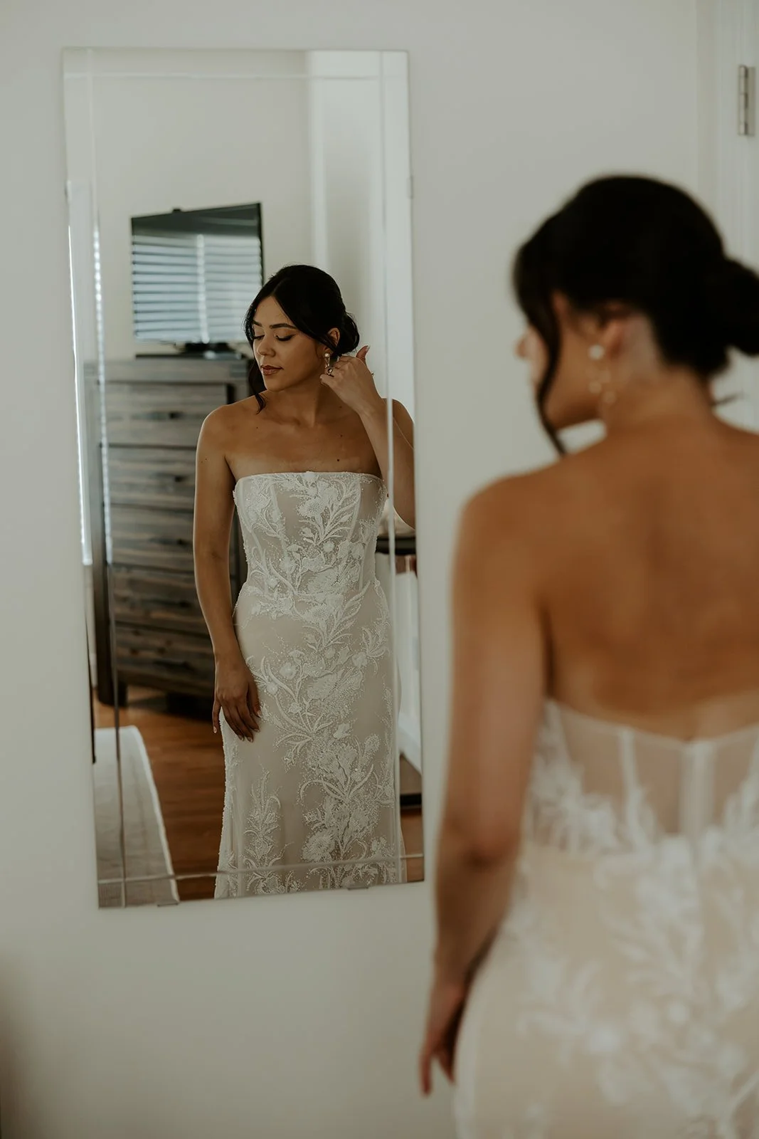 A bride in the mirror while getting ready for her wedding