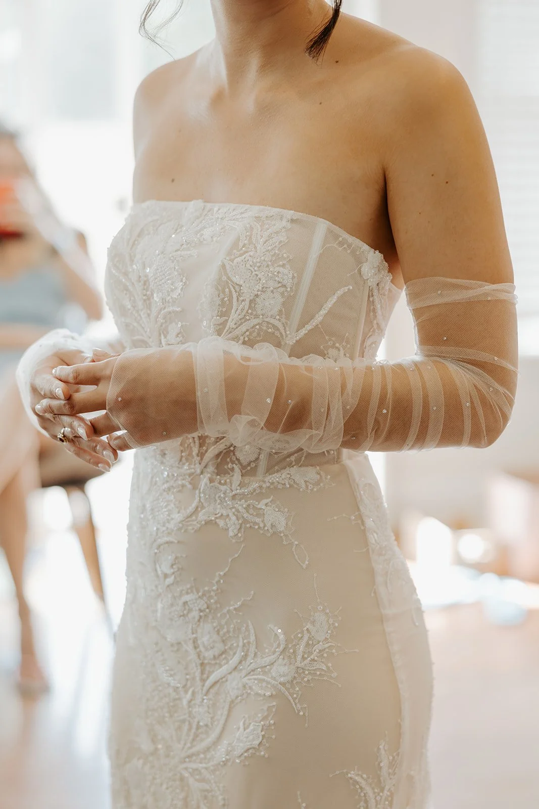 A bride in her wedding dress, marking shopping off of her wedding planning checklist