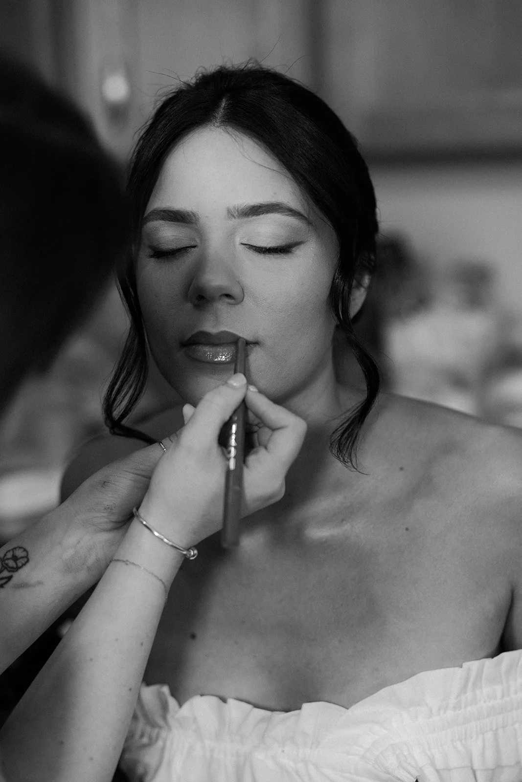 A bride having lipstick applied