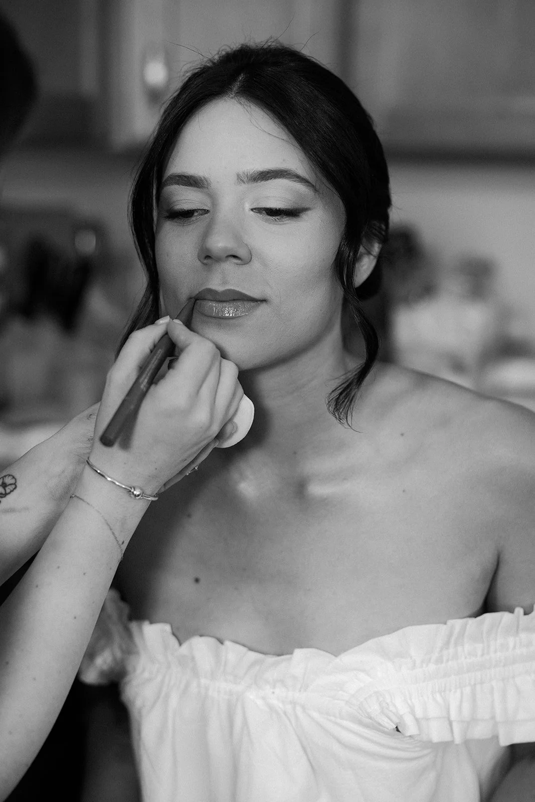 A bride having lipstick applied