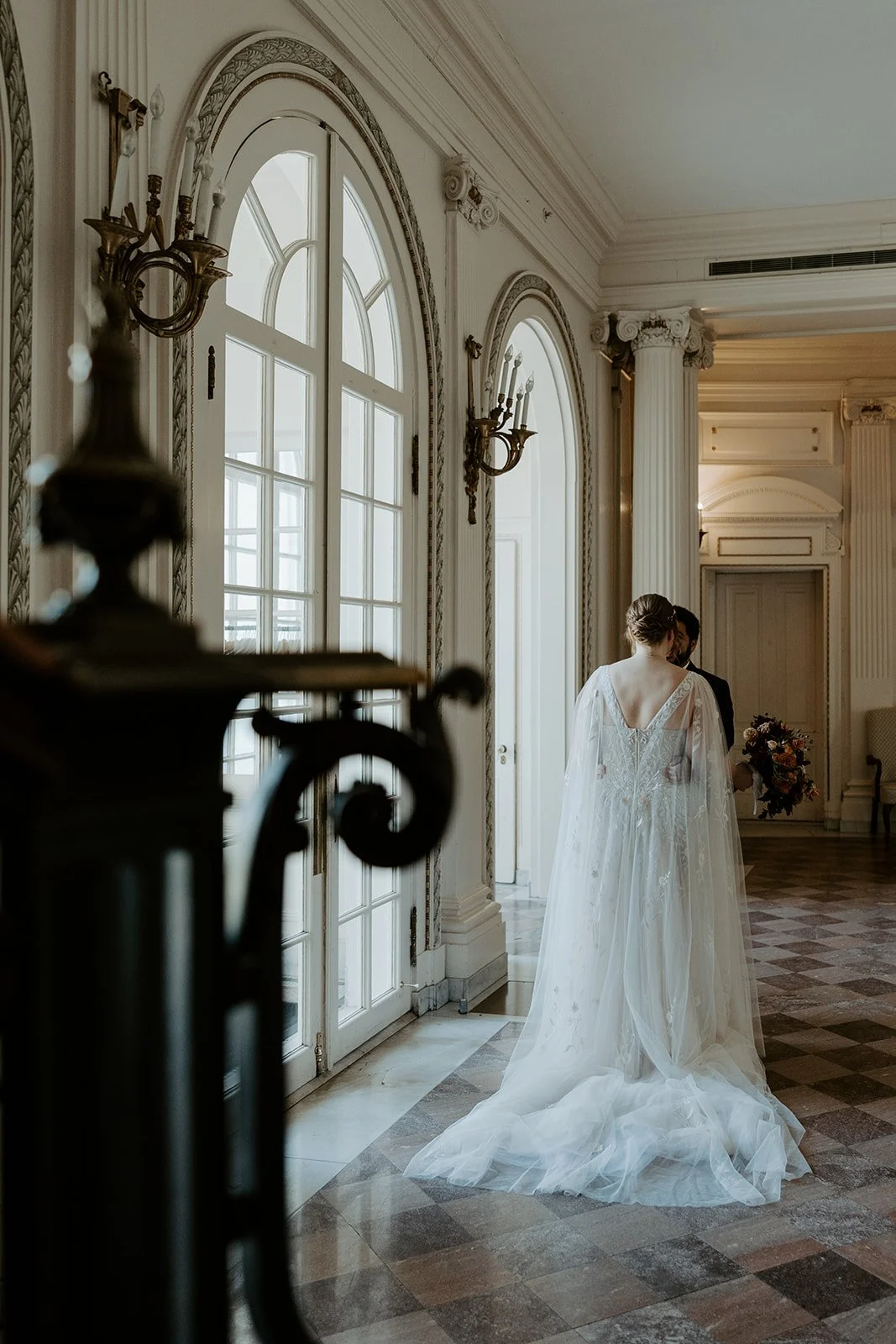 A bride and groom taking photos for a wedding planning checklist