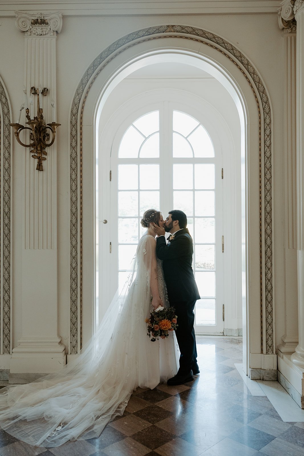 A bride and groom taking photos for a wedding planning checklist