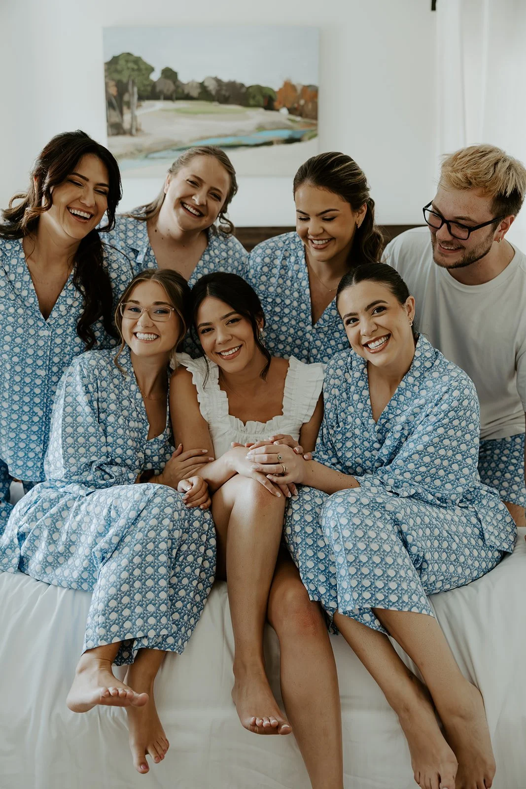 A bride and her bridal party laughing