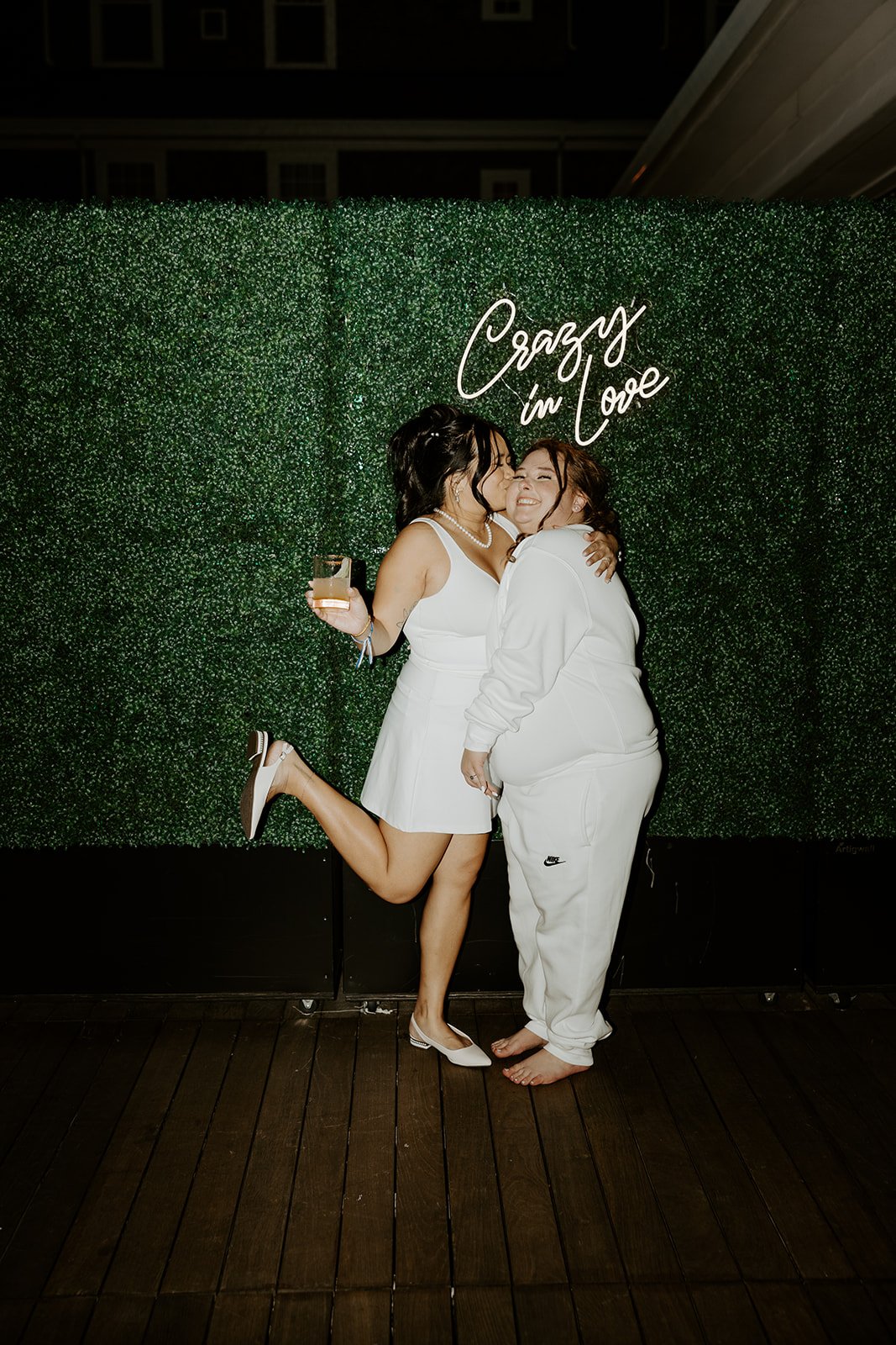 Two brides kissing at their wedding reception after their wedding planning checklist is complete