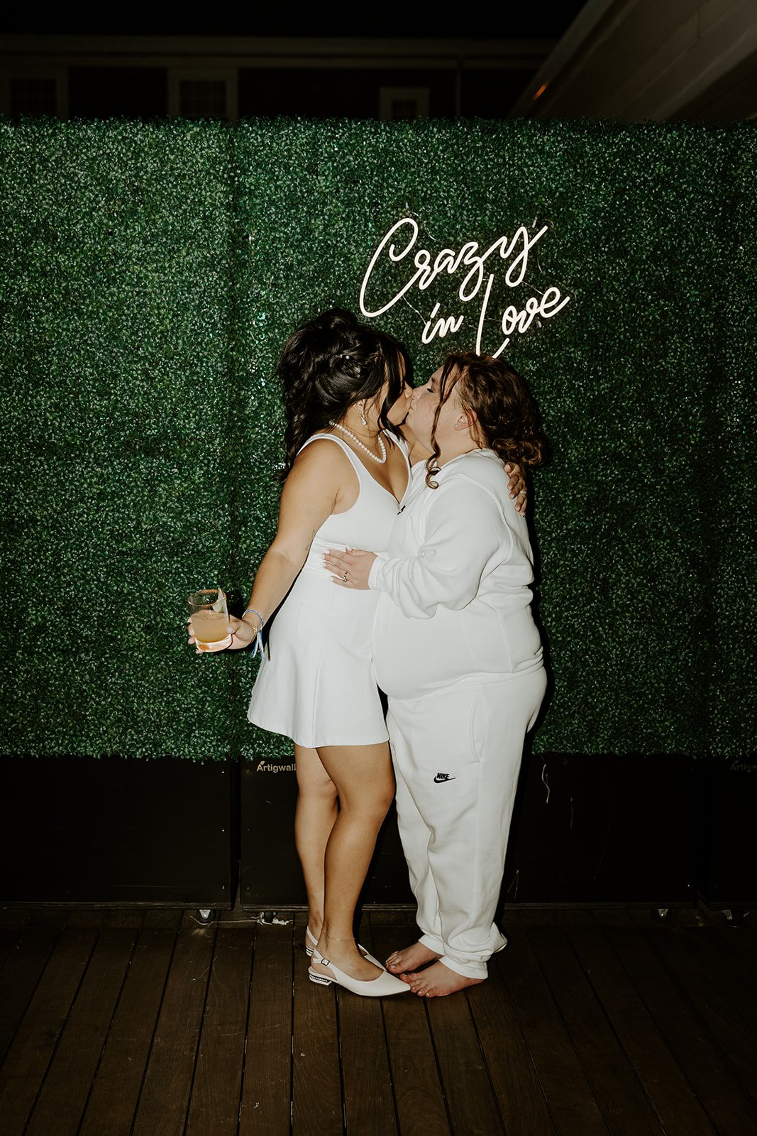 Two brides kissing at their wedding reception after their wedding planning checklist is complete