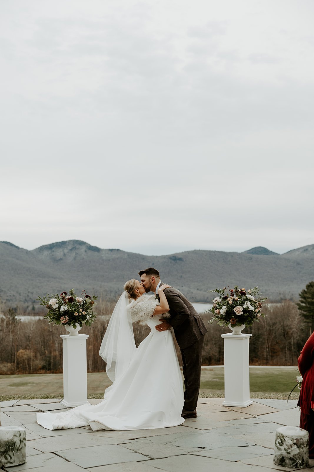 A bride and groom sharing their first kiss at their Vermont wedding venue, Mountain Top Resort