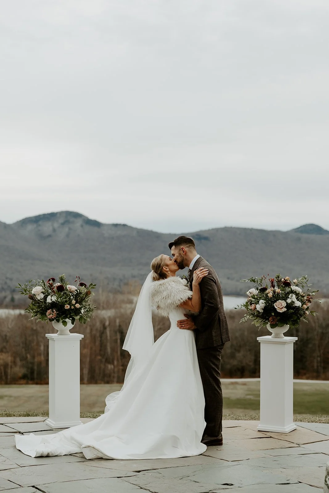 A bride and groom sharing their first kiss at their Vermont wedding venue, Mountain Top Resort