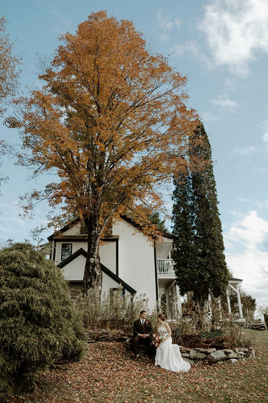 A bride and groom posing for photos at their Vermont wedding venue, Farm Road Estate