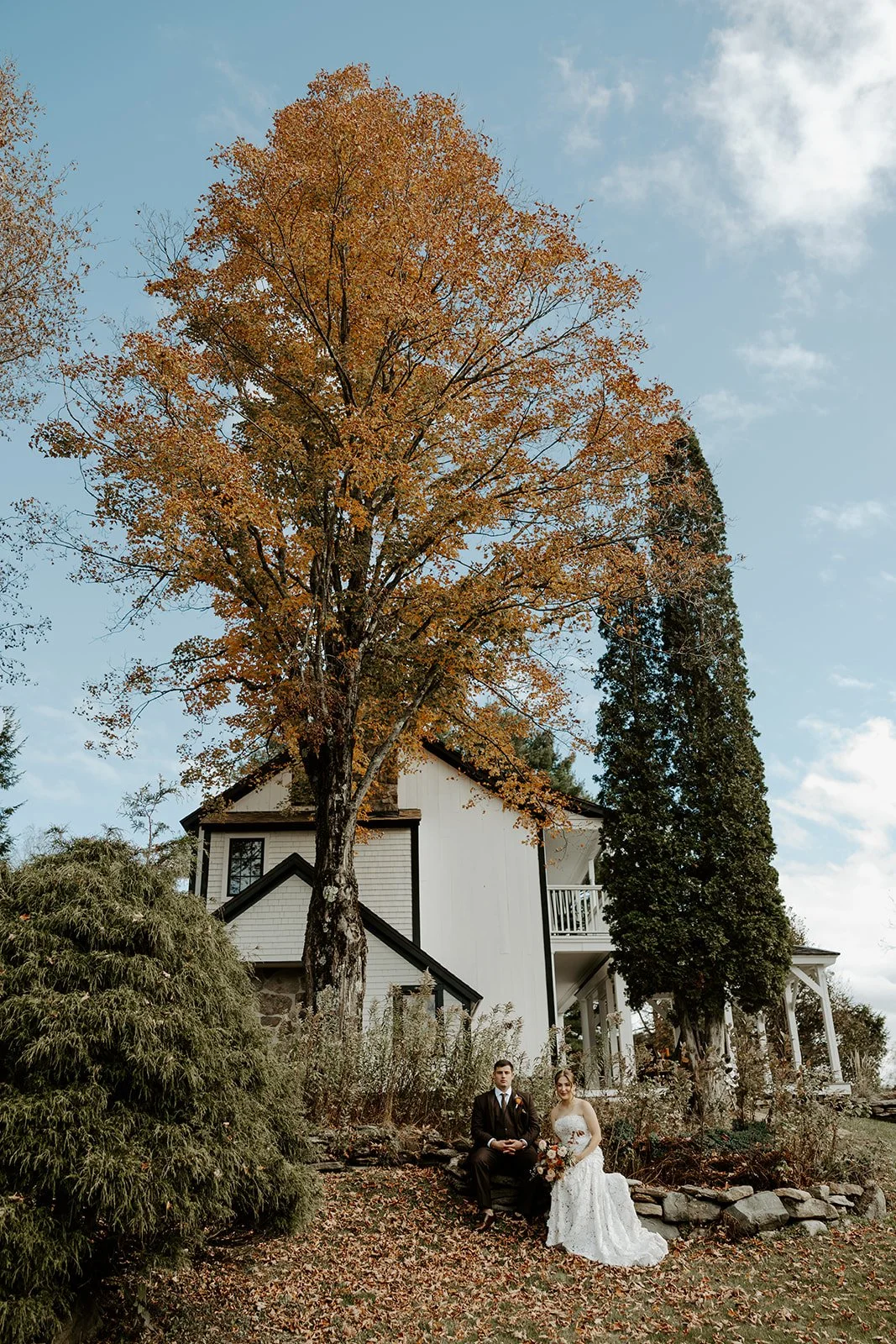 A bride and groom posing for photos at their Vermont wedding venue, Farm Road Estate