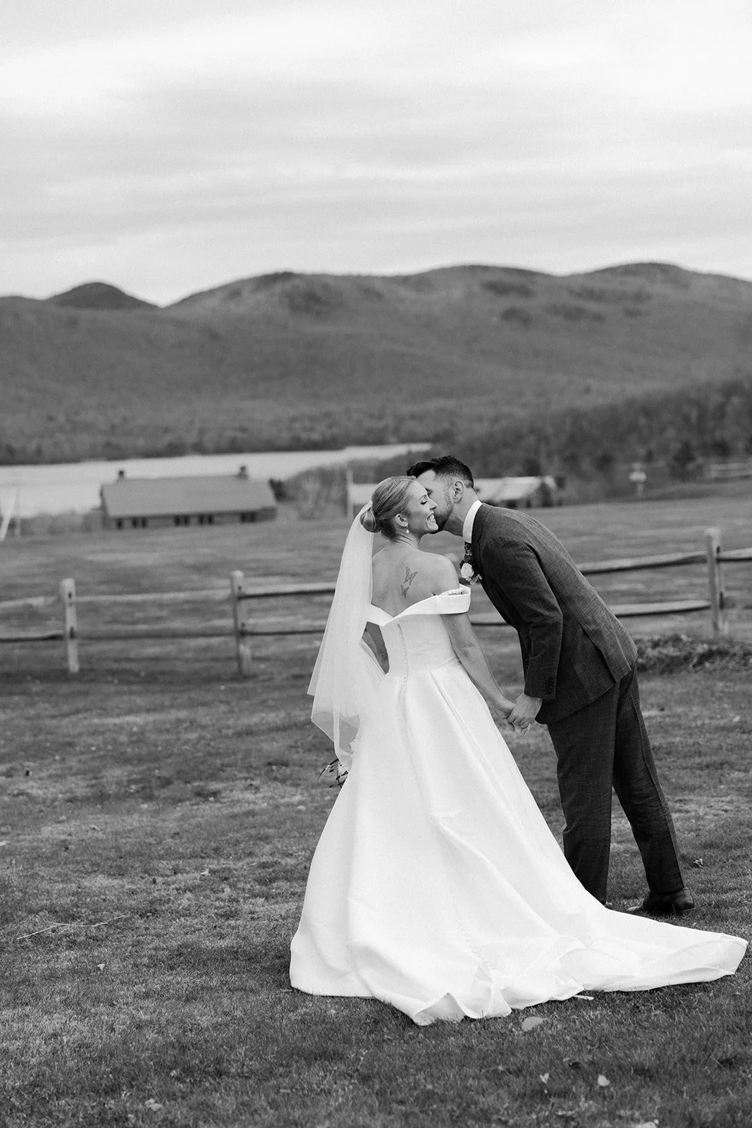 A bride and groom in a black and white wedding photo at their Vermont wedding venue