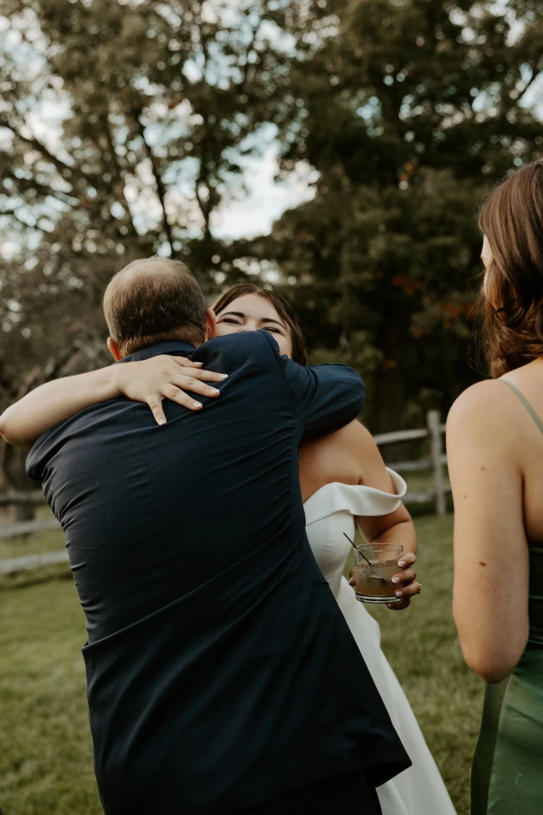 A bride hugging a wedding guest