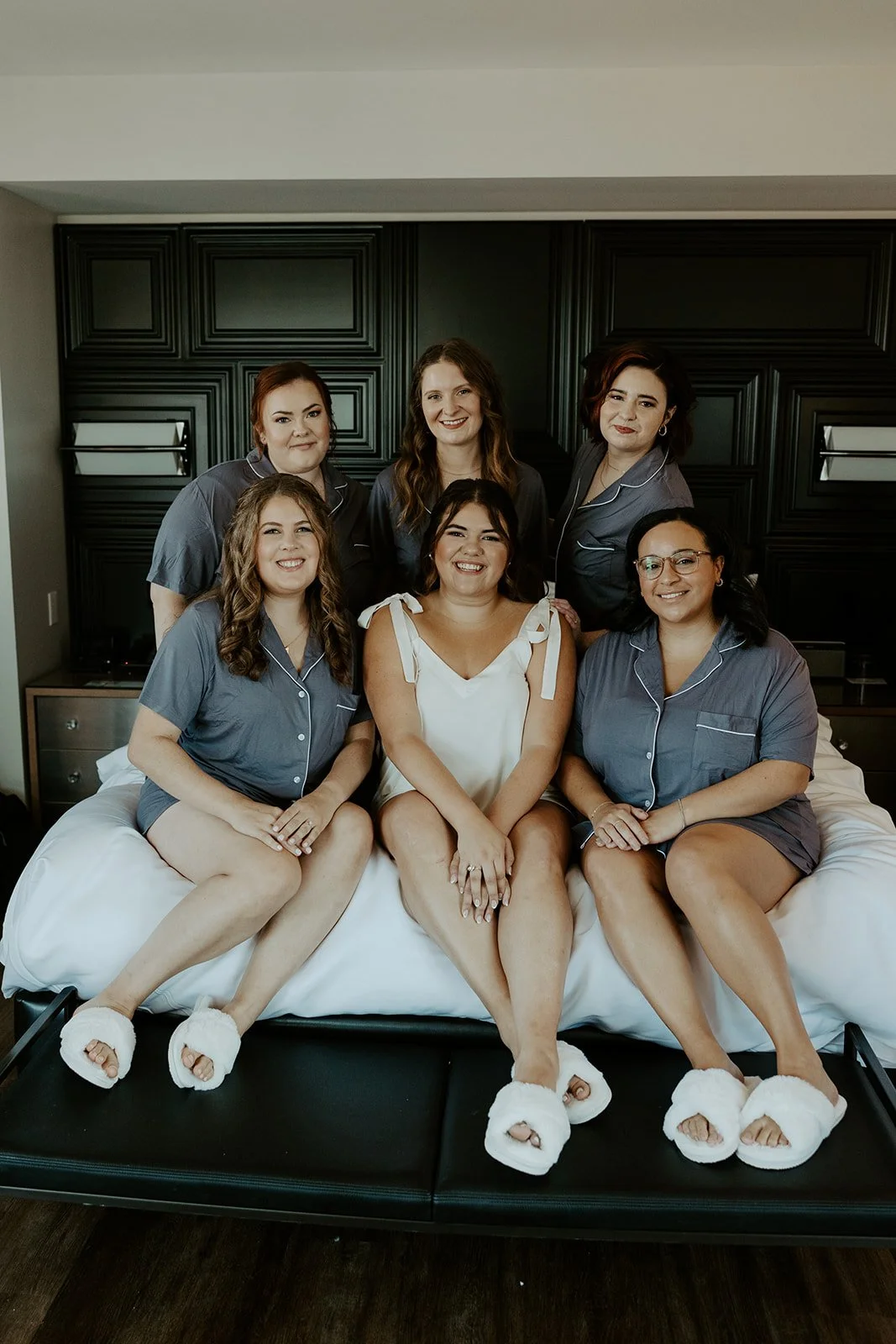 A bride and bridesmaids taking getting ready wedding photos at a hotel