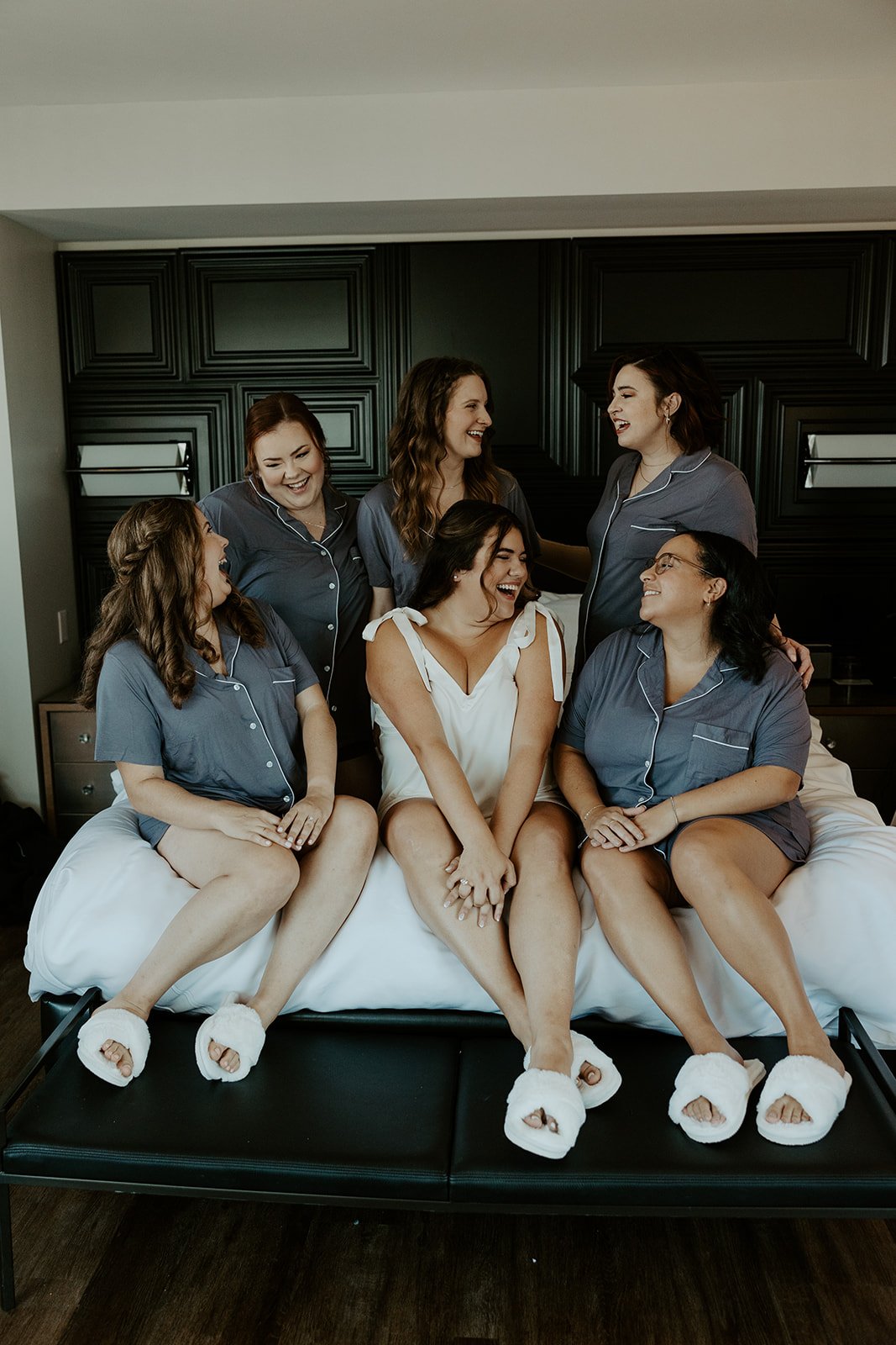 A bride and bridesmaids taking getting ready wedding photos at a hotel