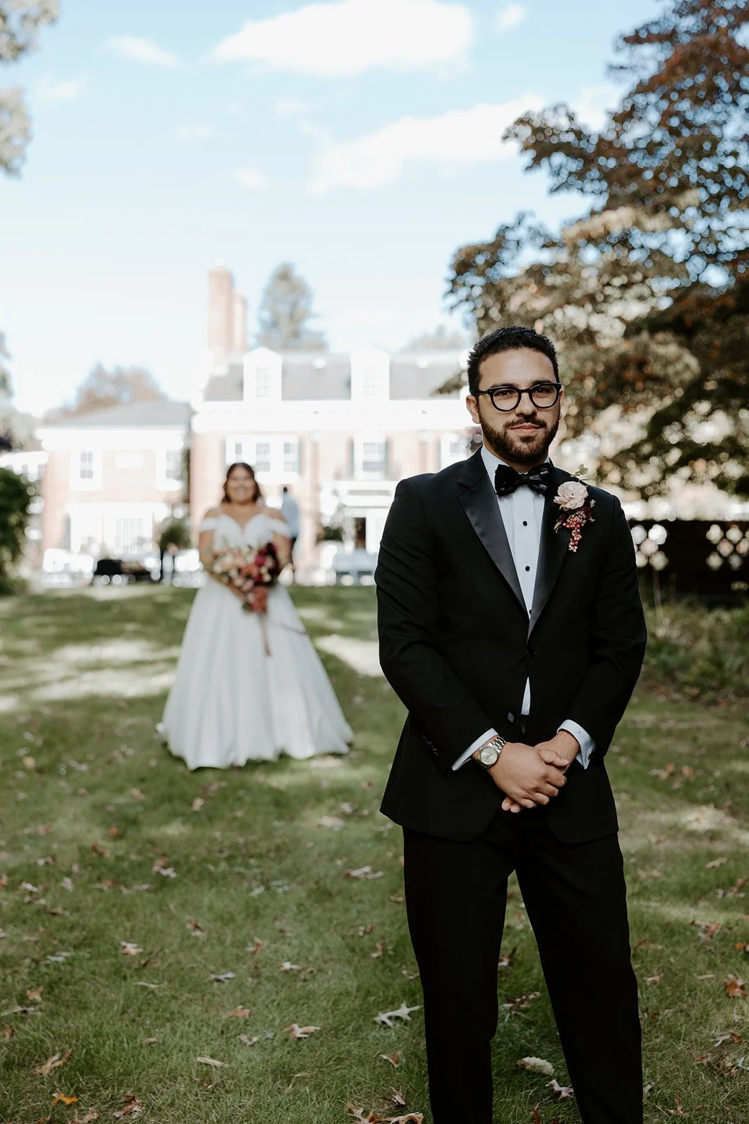 A bride walking up to a groom for a wedding first look at the bradley estate