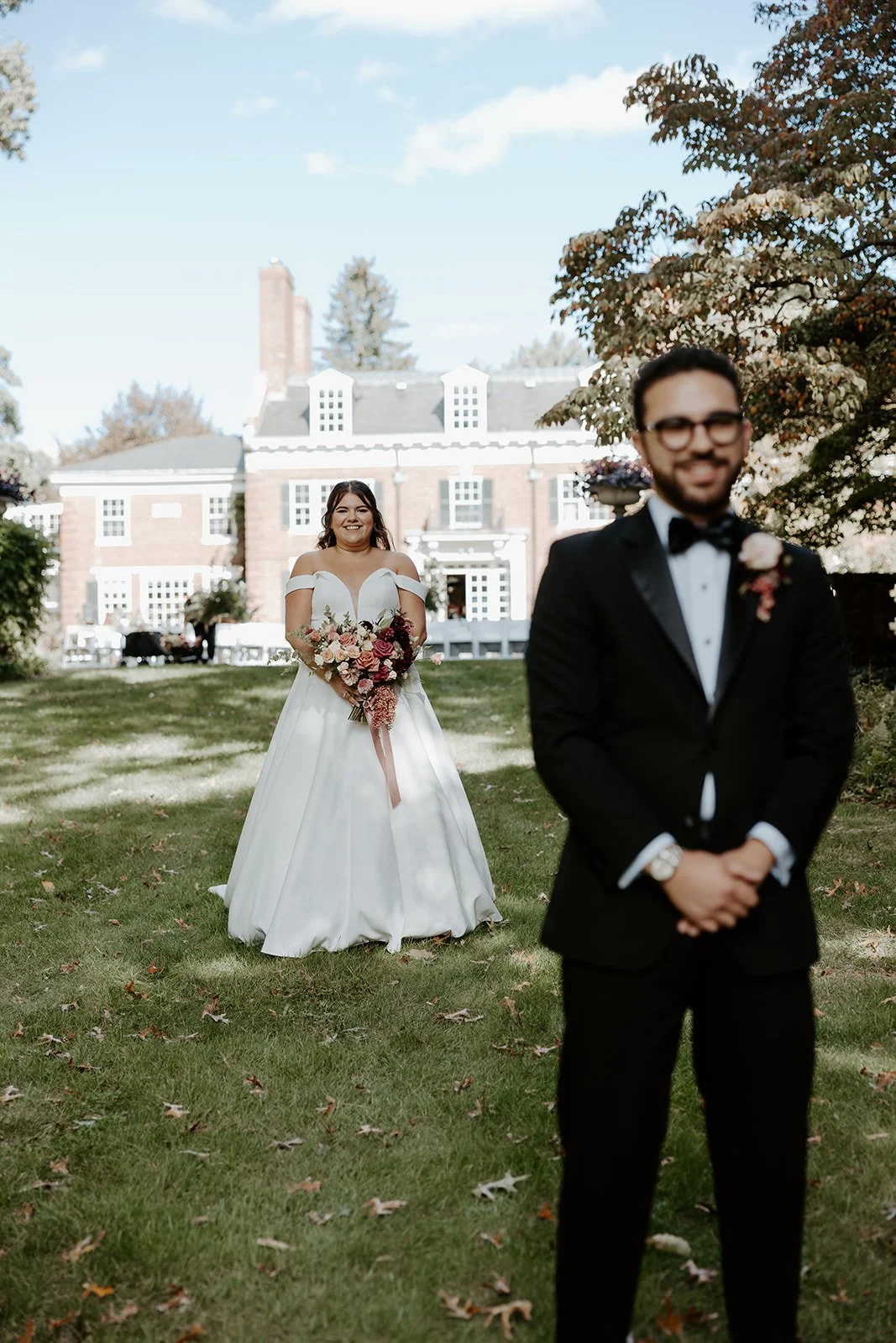 A bride walking up to a groom for a wedding first look at the bradley estate