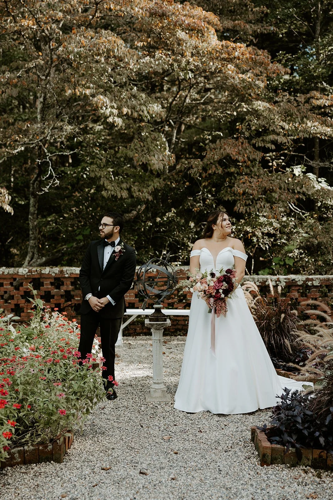 A bride and groom posing for wedding photos in the gardens at the bradley estate