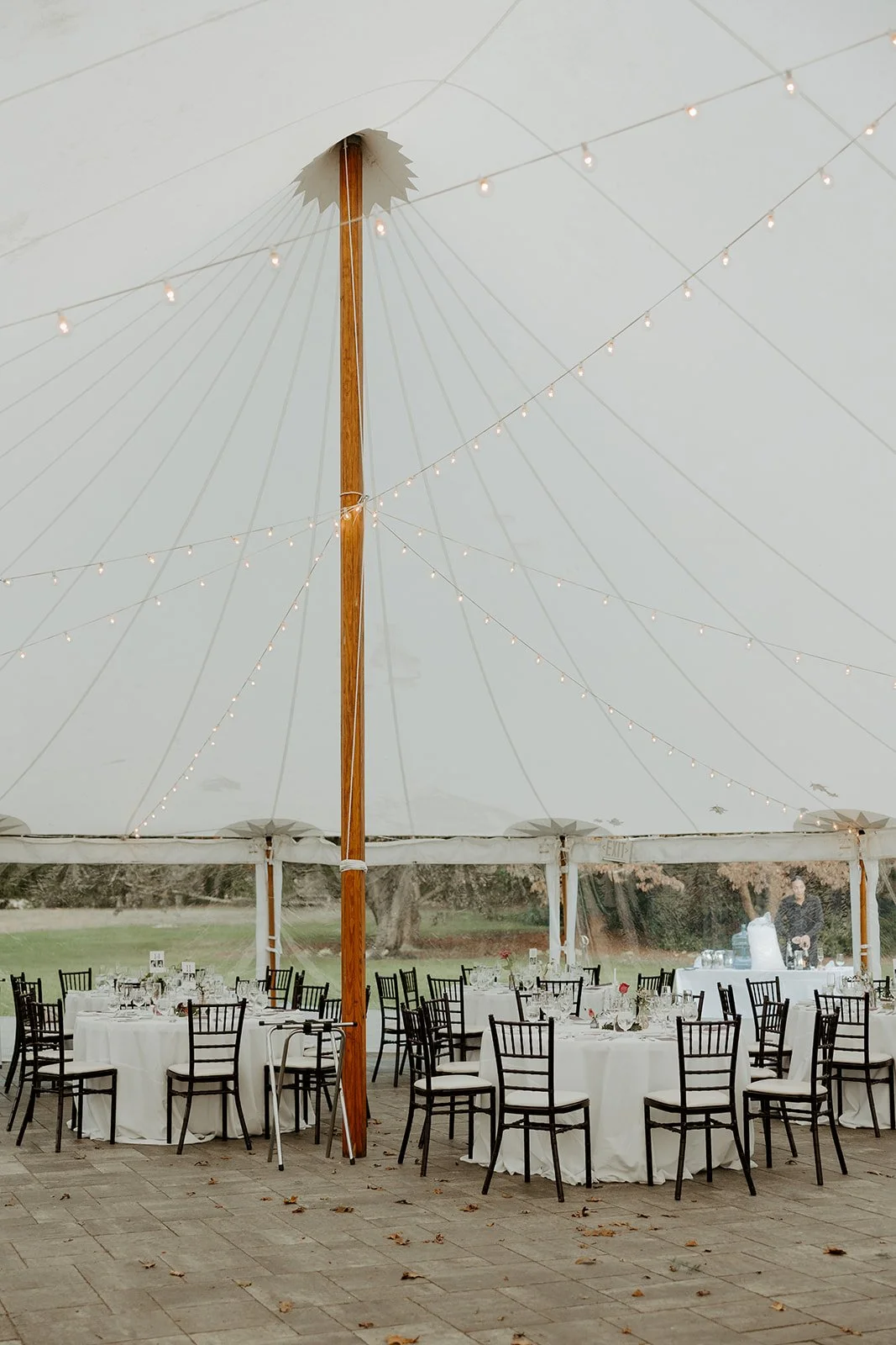 A wedding reception set up under a tent
