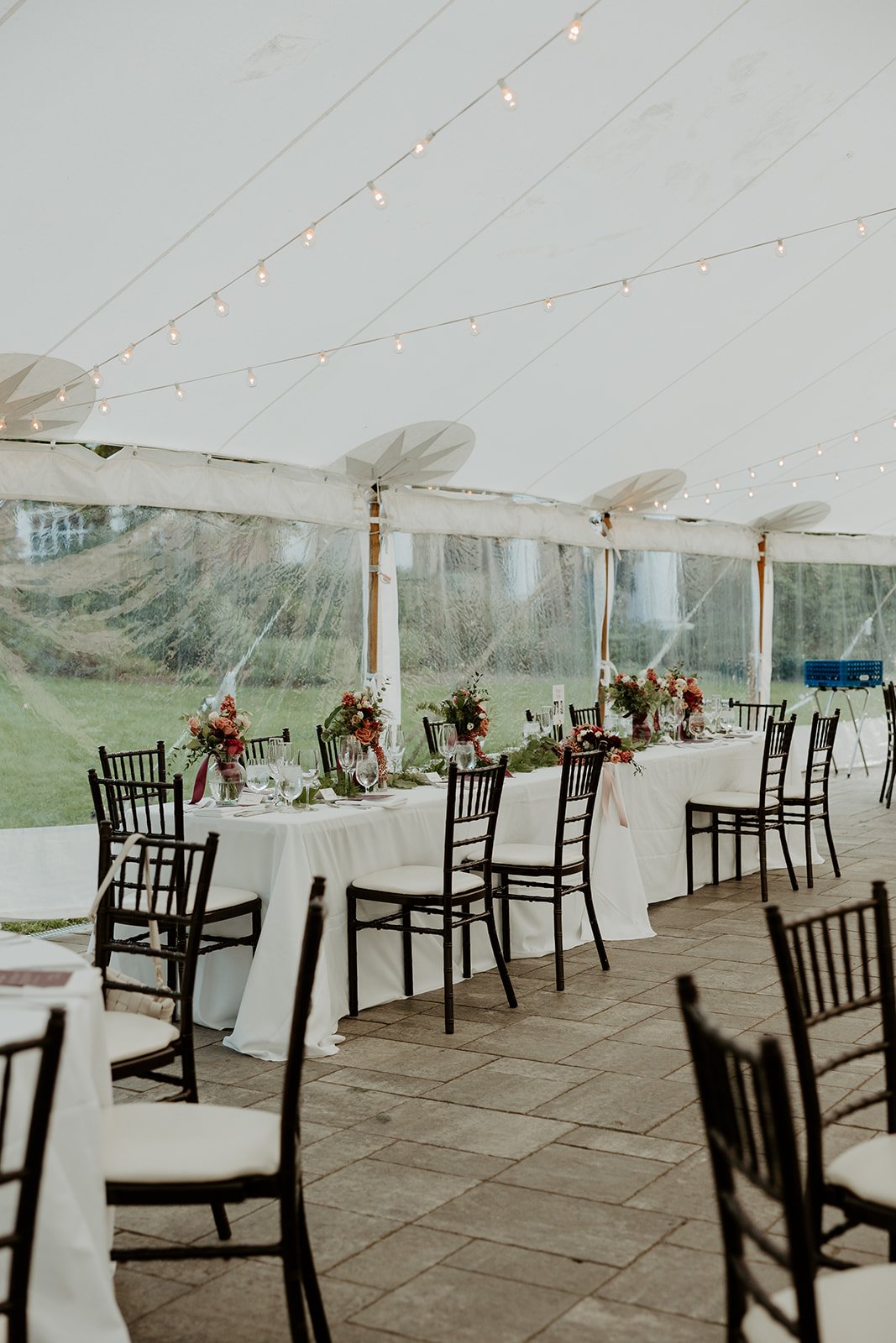 A wedding reception set up under a tent