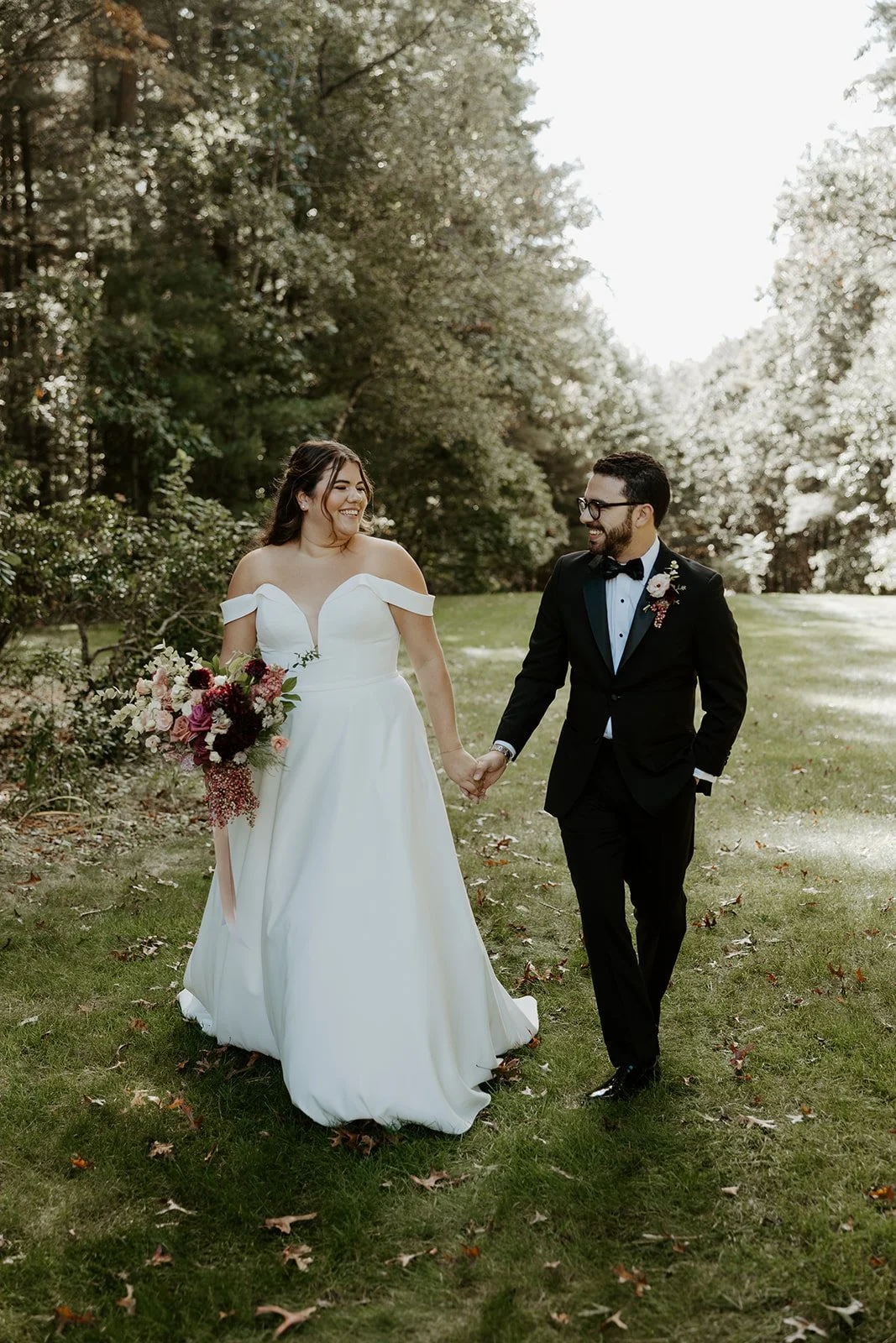 A bride and groom walking through their wedding venue, the bradley estate