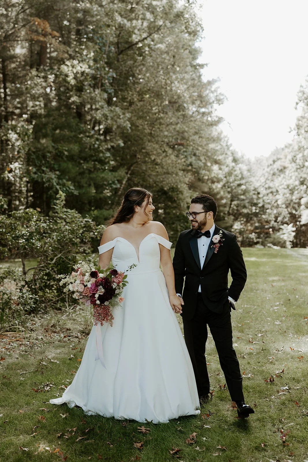 A bride and groom walking through their wedding venue, the bradley estate