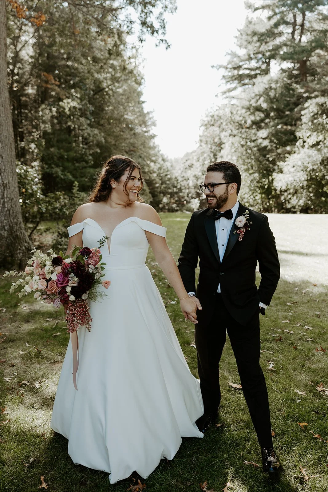 A bride and groom walking through their wedding venue, the bradley estate