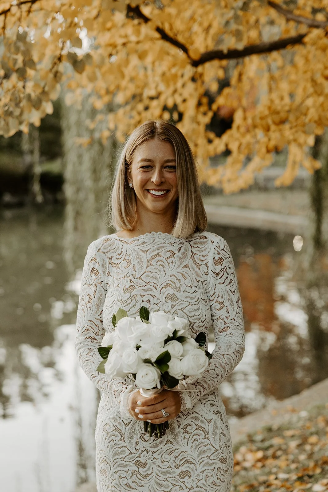 A bride posing for photos at her fall elopement
