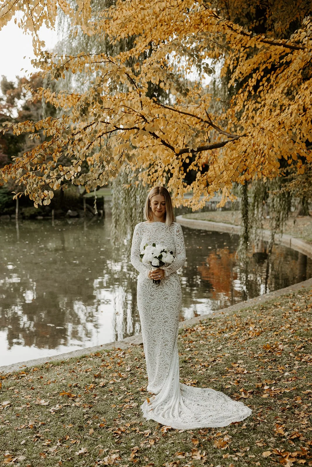 A bride posing for photos at her fall elopement