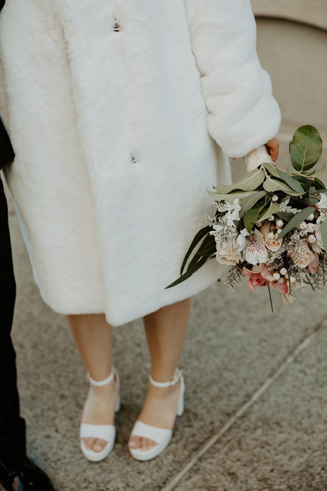 A woman wearing a jacket showing how to plan an elopement in the winter