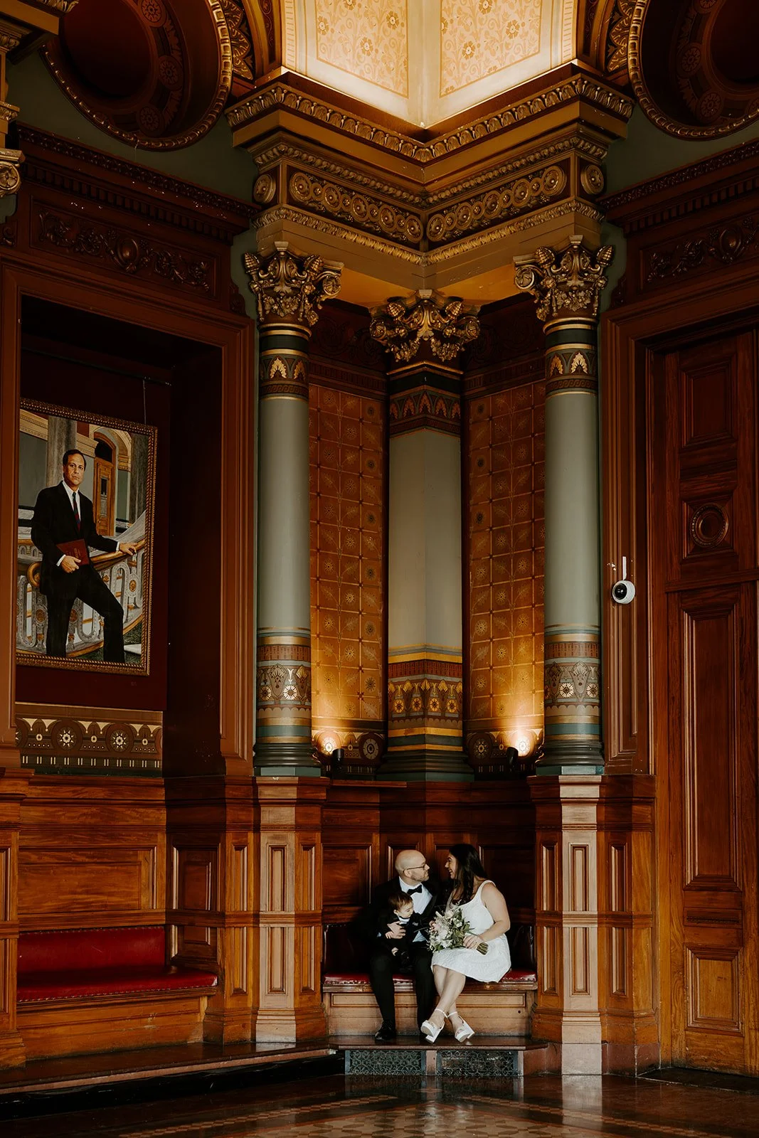 A bride and groom posing for elopement photos in providence city hall