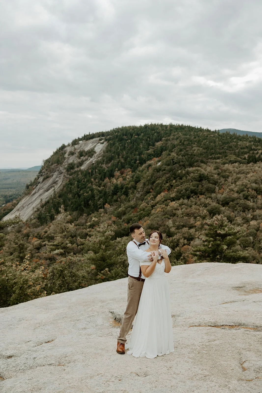 A bride and groom taking elopement photos at cathedral ledge