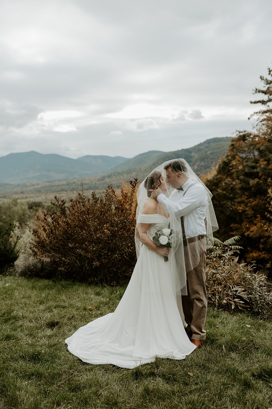 A bride and groom taking elopement photos at cathedral ledge