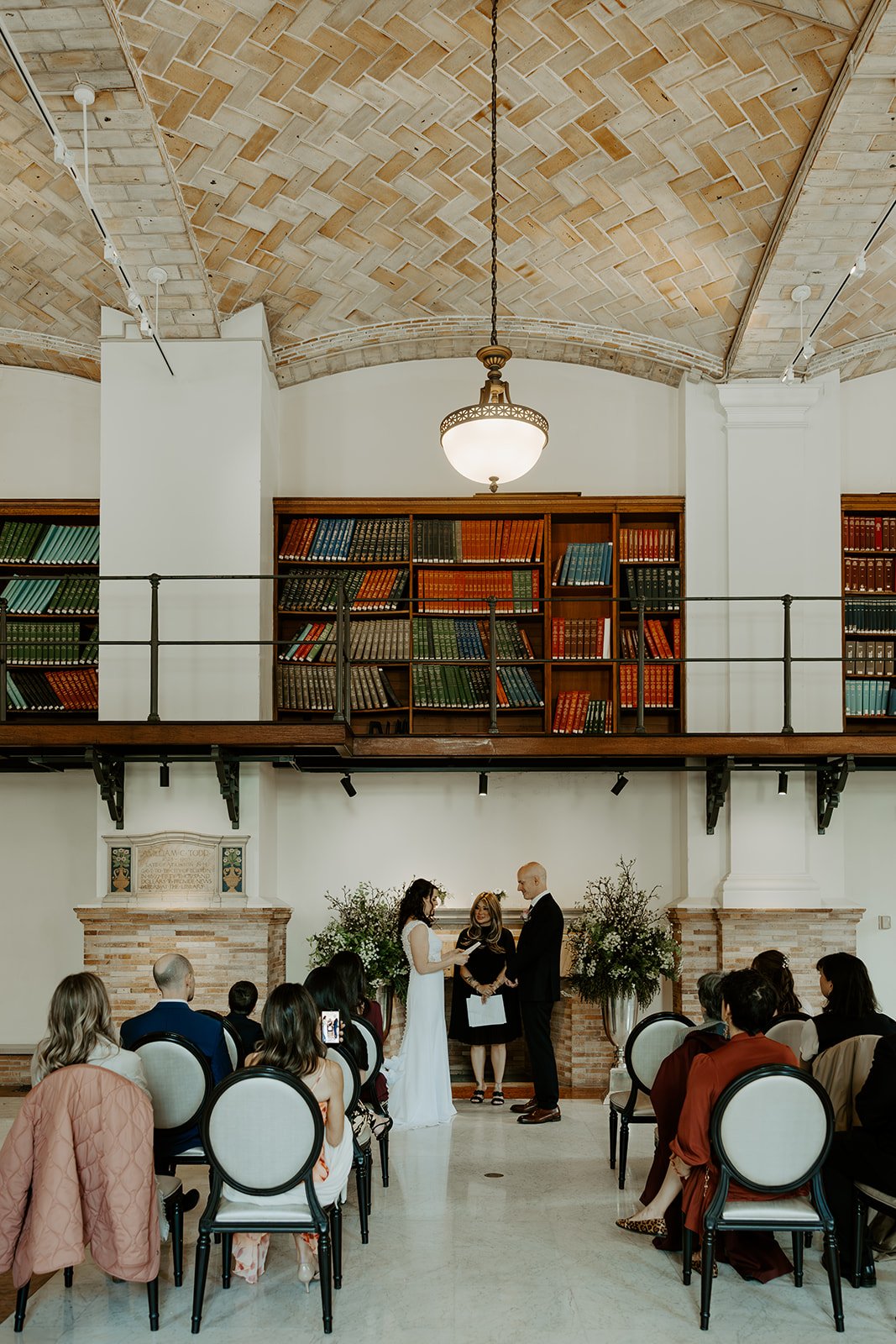 A birde and groom at their elopement after learning how to plan an elopement at boston public library