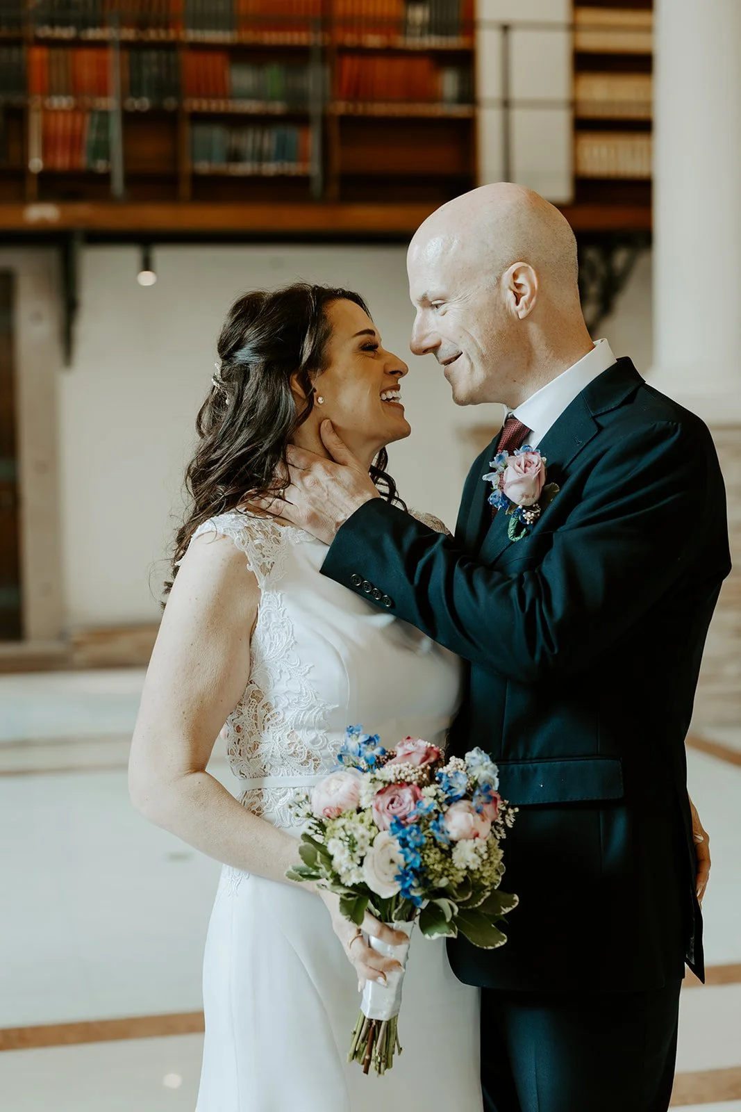 A bride and groom taking elopement photos in boston public library