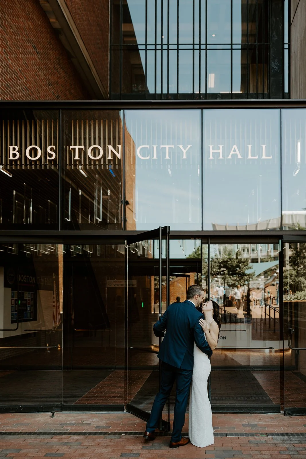 A birde and groom entering their city hall wedding
