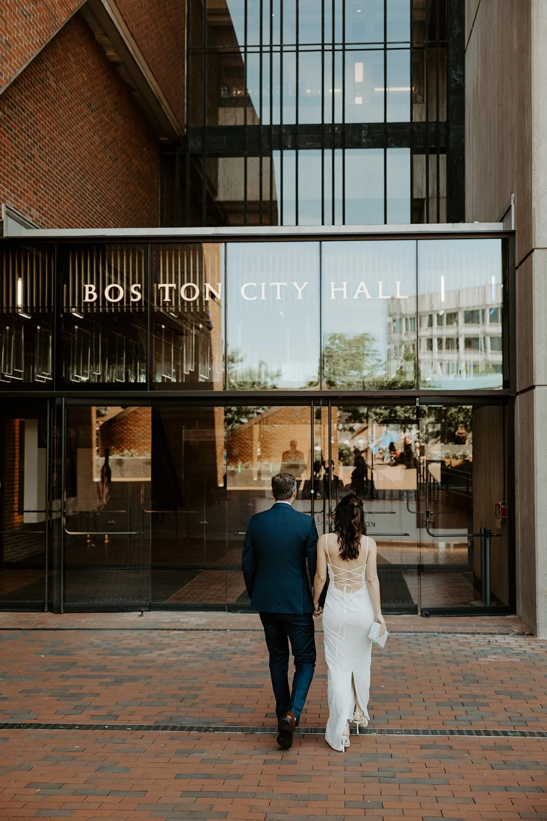 A birde and groom entering their city hall wedding