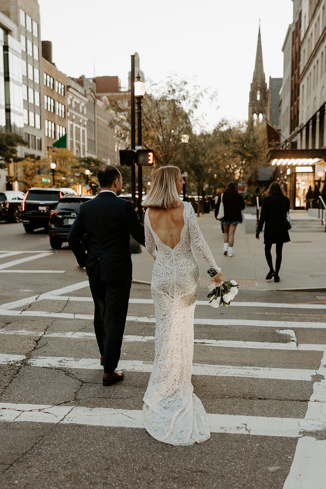 A bride and groom on the street after their boston elopement