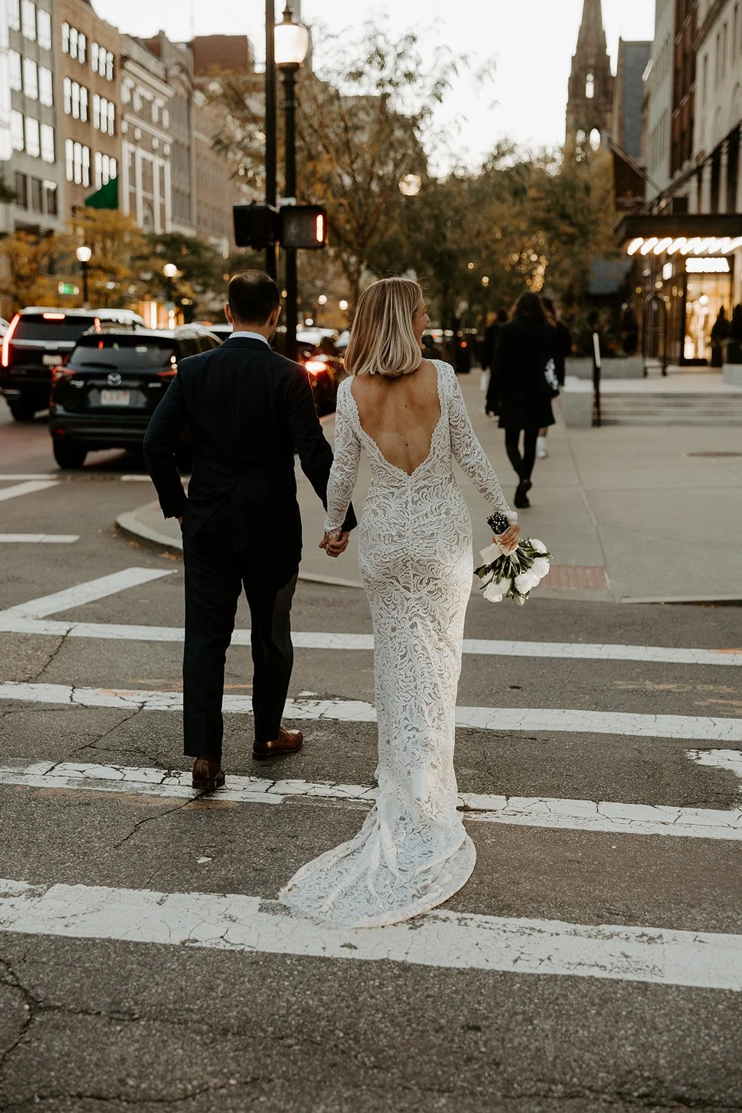 A bride and groom on the street after their boston elopement